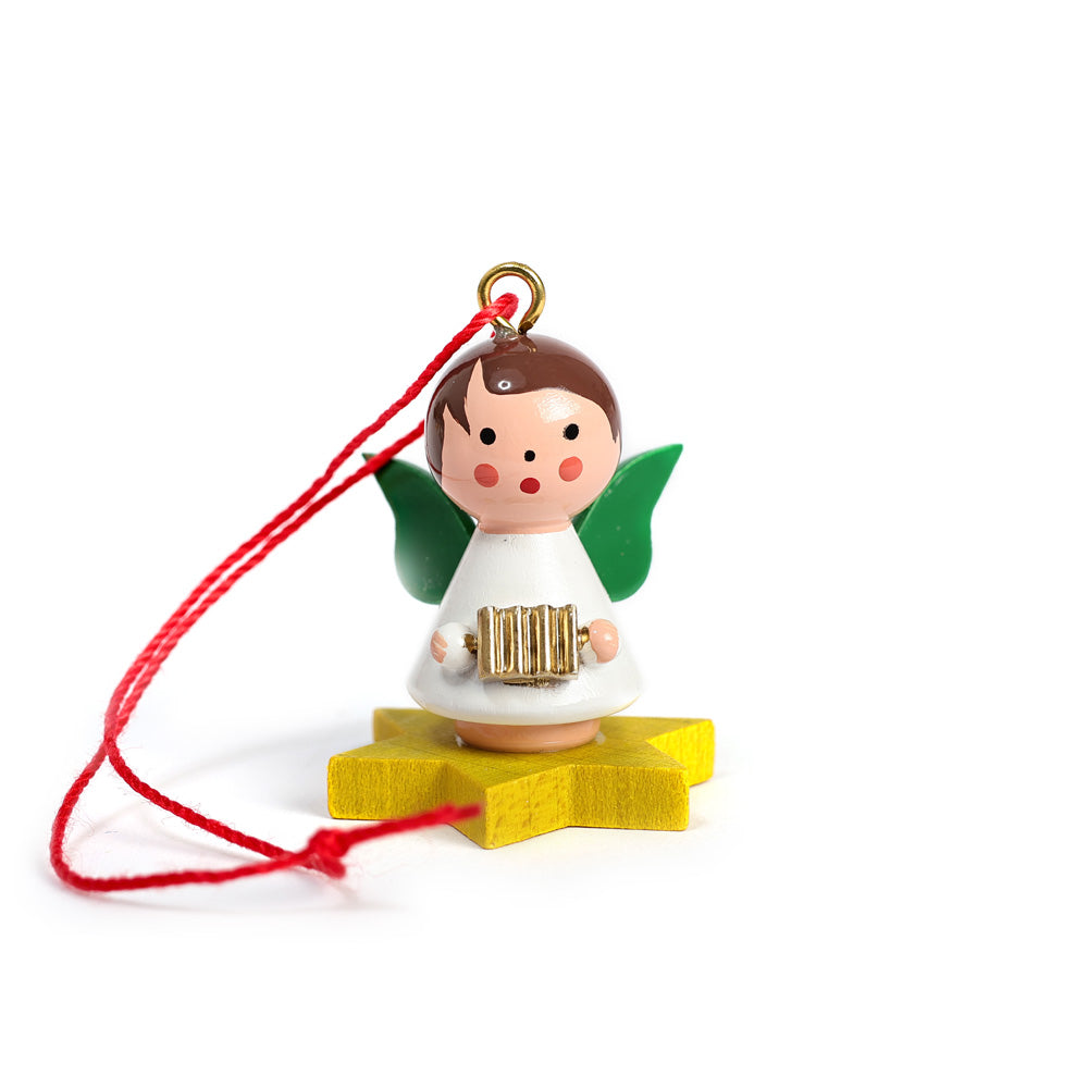 Little angel on yellow star with accordion